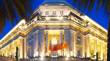 The exterior of The Fullerton Hotel and the palm trees flanking the entrance