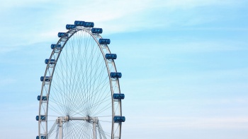 Part of the Singapore Flyer against the blue sky