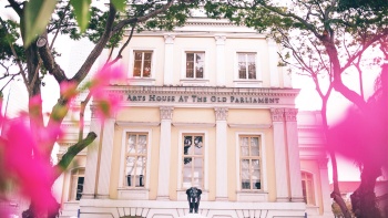 Exterior of the House of Arts in the Old Parliament Building，facade decorated with pink flowers 